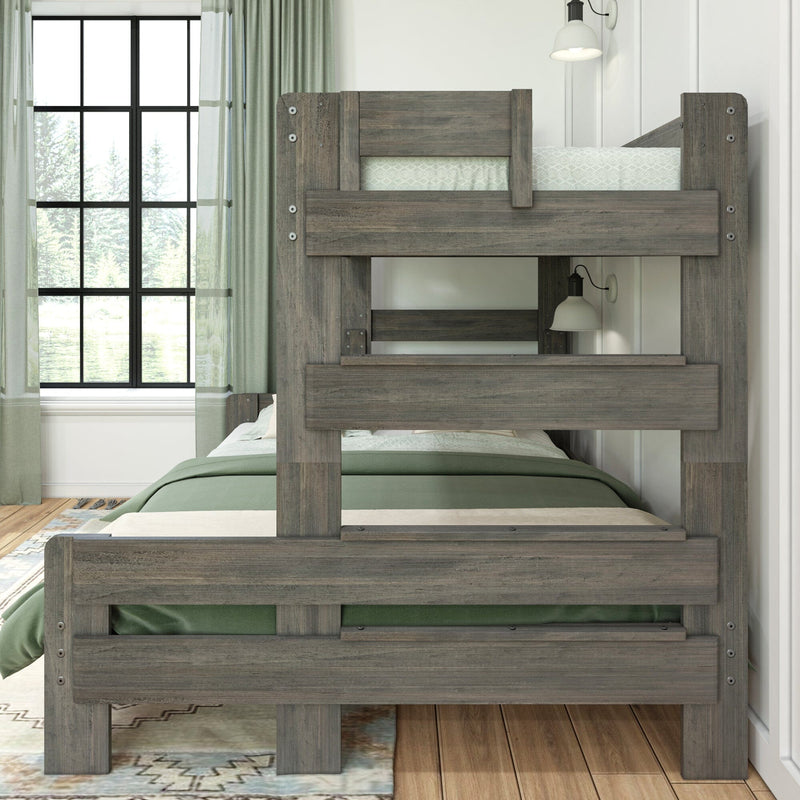 Gray weathered solid wood bunk bed in a modern farmhouse bedroom with green bedding, wall sconce, large window and hardwood floor