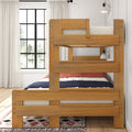 Natural wood twin-over-twin bunk bed in modern farmhouse kids' bedroom with navy and red bedding, patterned rug, white curtains, black-framed window and wall sconce