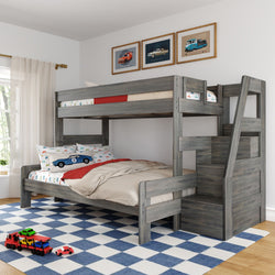 Gray wooden twin-over-full bunk bed with staircase storage, car-themed bedding and pillows, blue checkered rug in bright kids' bedroom