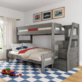 Gray loft bunk bed with car-themed bedding in kids' bedroom, framed car prints and toy car carrier on blue checkered rug