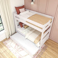 White wooden bunk bed with pull-out trundle in kids' room, neutral beige bedding and rust accent pillows against pink paneled wall and window curtains