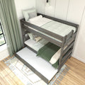Modern gray wooden twin-over-twin bunk bed with trundle, mint green bedding and patterned pillows in a cozy kids' bedroom with green curtains and area rug