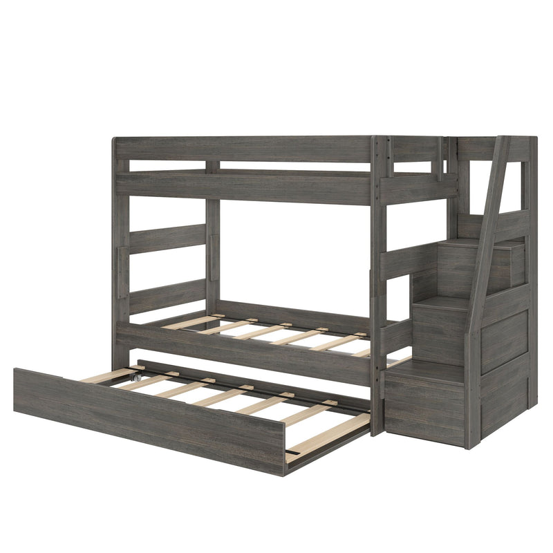 Gray wooden twin-over-full bunk bed with built-in staircase, under-bed trundle, slatted mattress platforms and modern farmhouse finish