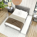 Top-down view of modern farmhouse bedroom with gray wood bed, neutral linen bedding, rattan pendant light, wood floor, potted plant