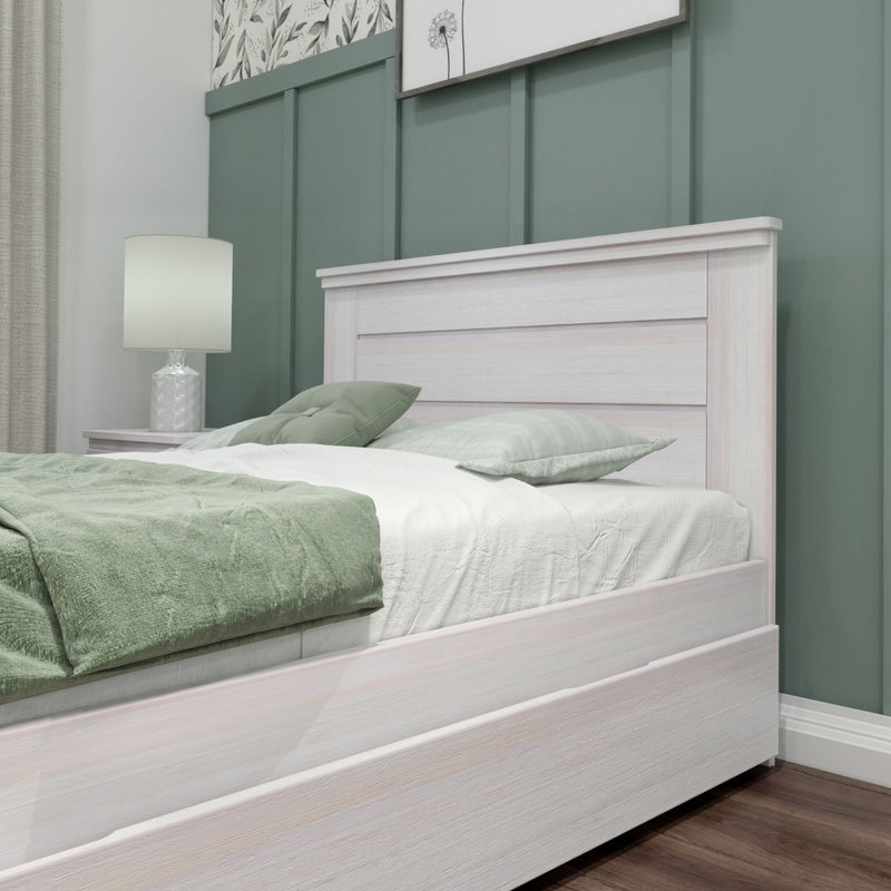Elegant white wooden bed frame with green bedding in a modern bedroom with decorative wall paneling.
