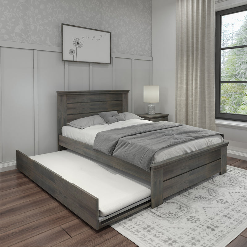 Rustic wooden trundle bed in a modern bedroom with gray bedding, natural light from a large window, and elegant decor elements.