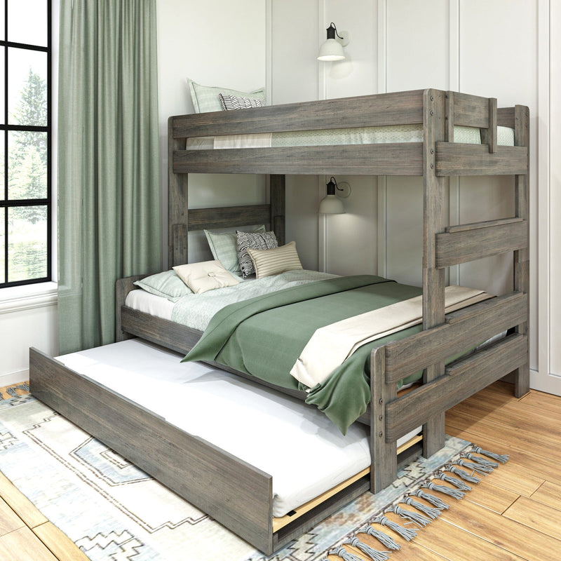 Rustic gray wood bunk bed with pull-out trundle, sage green bedding and patterned pillows in a modern farmhouse kids' bedroom with large window and curtains