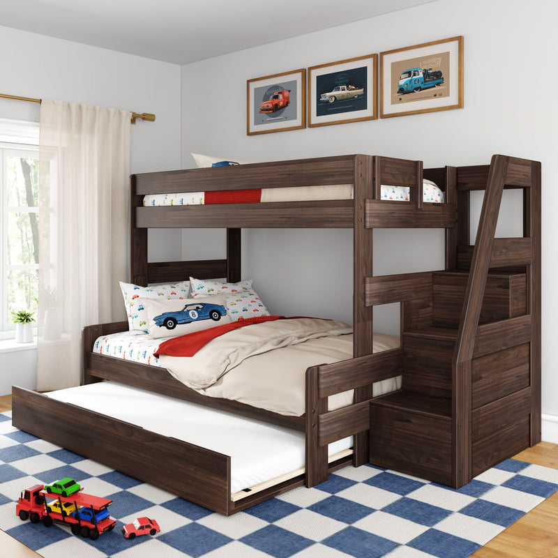 Dark wood kids bunk bed with trundle and storage stairs, car-themed bedding and toy cars on blue check rug