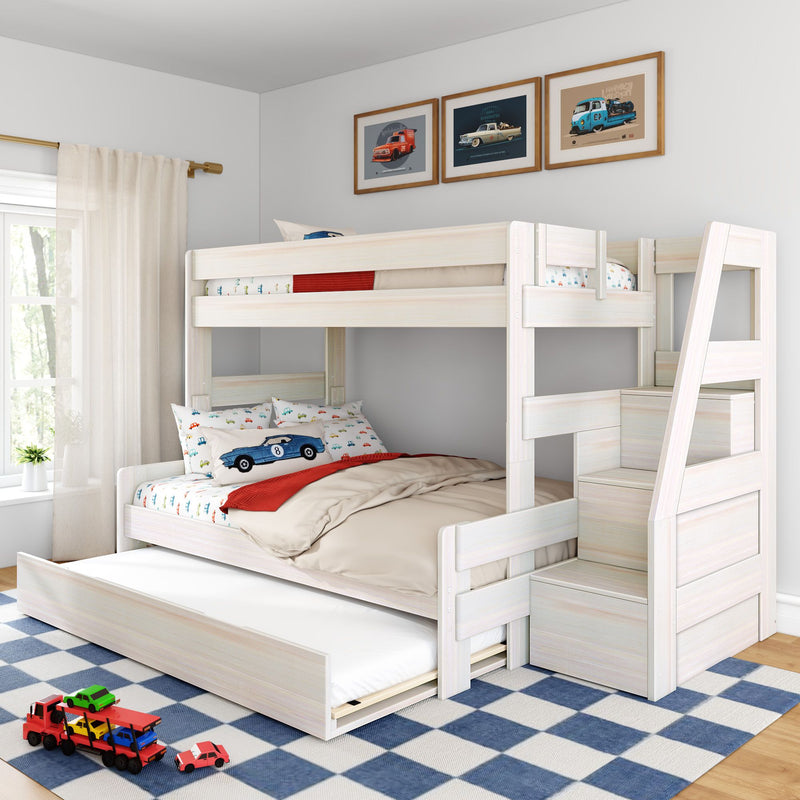 White wooden kids bunk bed with stairs and trundle, car-themed bedding and toy cars in bright children's bedroom with blue check rug and framed vintage car prints