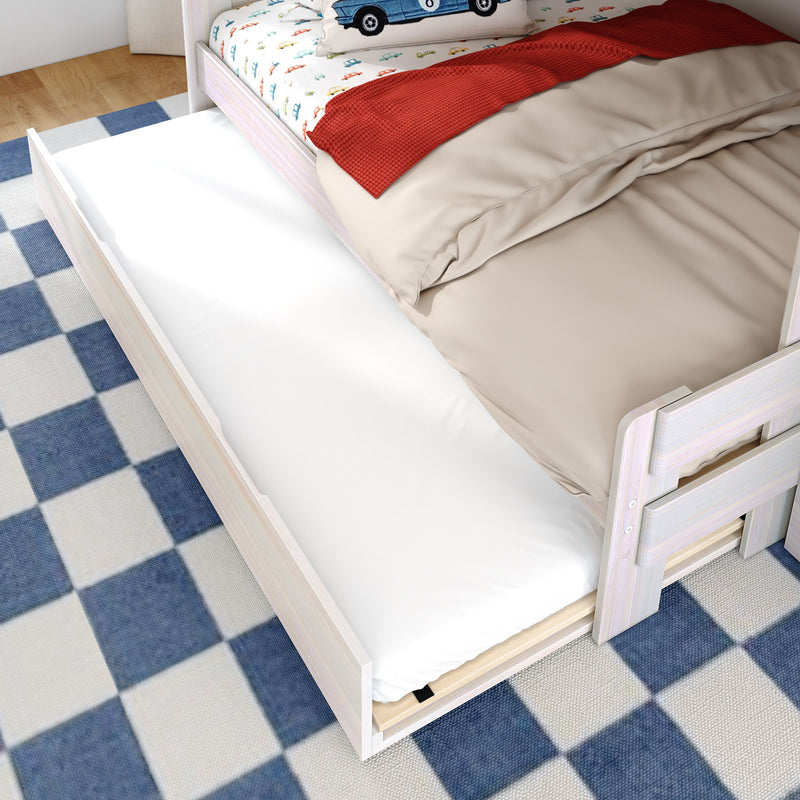 Wooden trundle bed with pull-out white mattress and beige duvet, under-bed storage in kids' bedroom on blue checkered rug