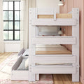 Whitewashed wooden bunk bed with pull-out trundle and storage drawers in a bright girls' bedroom with large grid window, neutral bedding, and a wall-mounted lamp