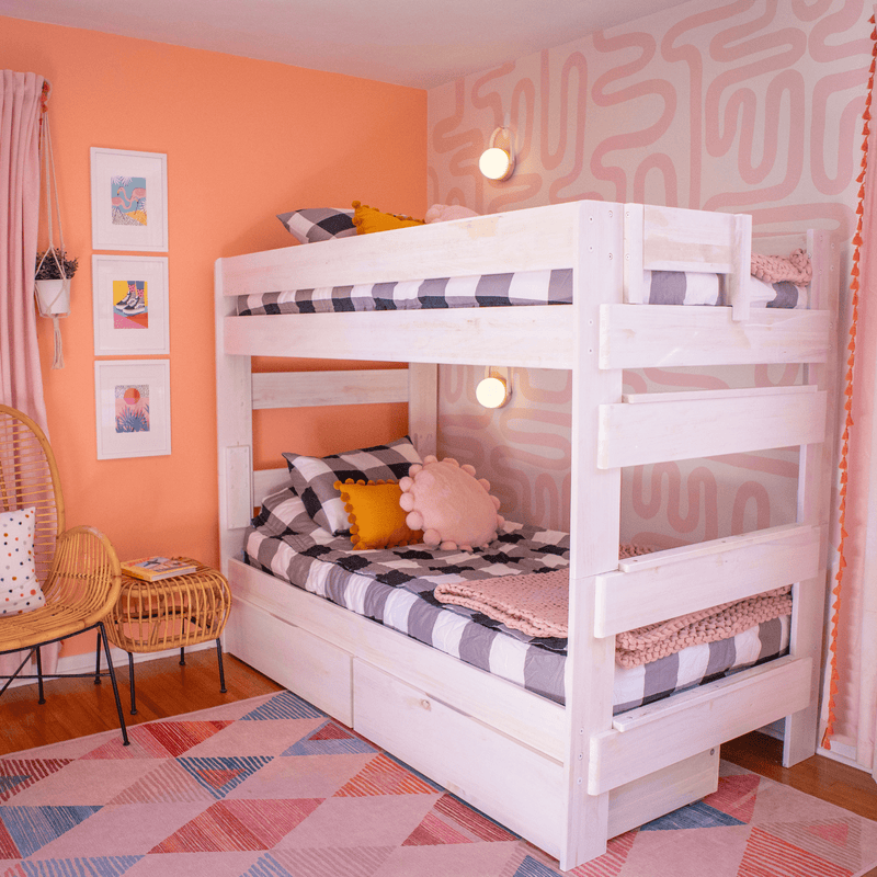 Bright children's bedroom with modern white bunk beds and colorful geometric decor.