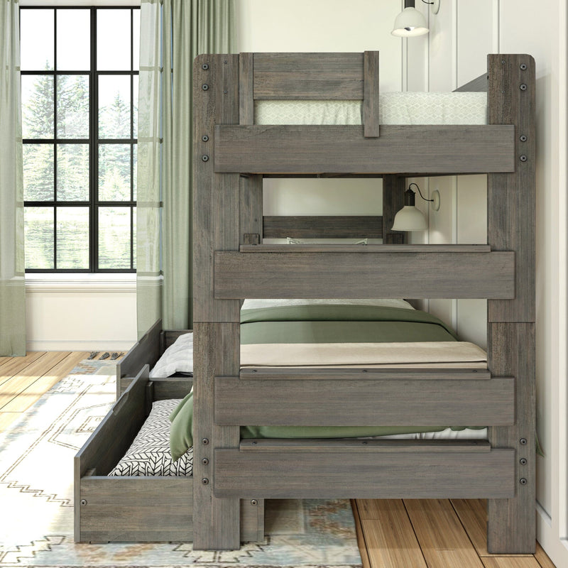 Wooden bunk bed with pull-out trundle in modern bedroom setting.