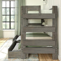 Rustic gray twin-over-twin wooden bunk bed with trundle drawer, green bedding and built-in guardrail in a bright farmhouse bedroom