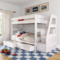 White wooden twin-over-twin bunk bed with staircase and built-in storage drawers in a bright kids' bedroom, car-themed bedding and framed vintage car prints, toy cars on a blue checkered rug