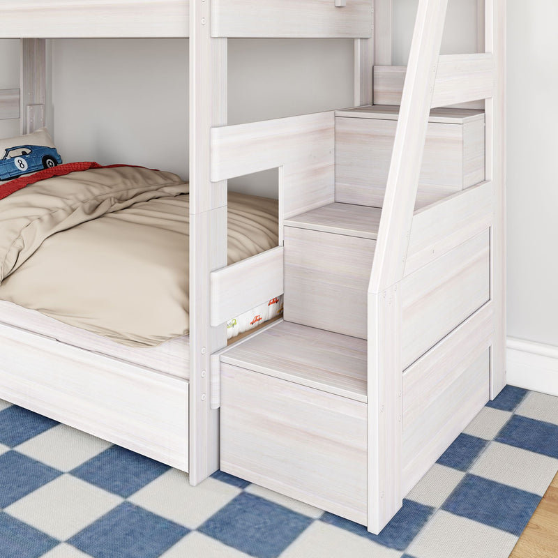 Whitewashed light-wood bunk bed with staircase storage drawers and beige bedding in a kids' bedroom, toy car pillow and blue checkered rug