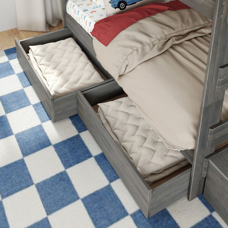 Grey wood bunk bed with pull-out under-bed storage drawers holding folded quilts, beige bedding and car-print sheet on blue checkered rug