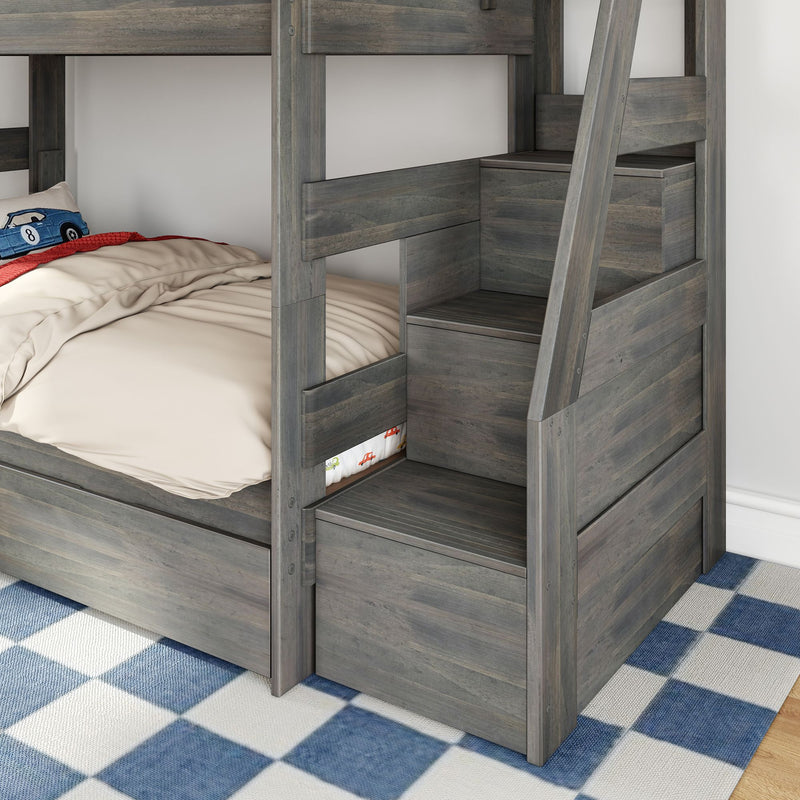 Gray wooden twin-over-twin bunk bed with built-in staircase storage drawers and beige bedding in kids' bedroom