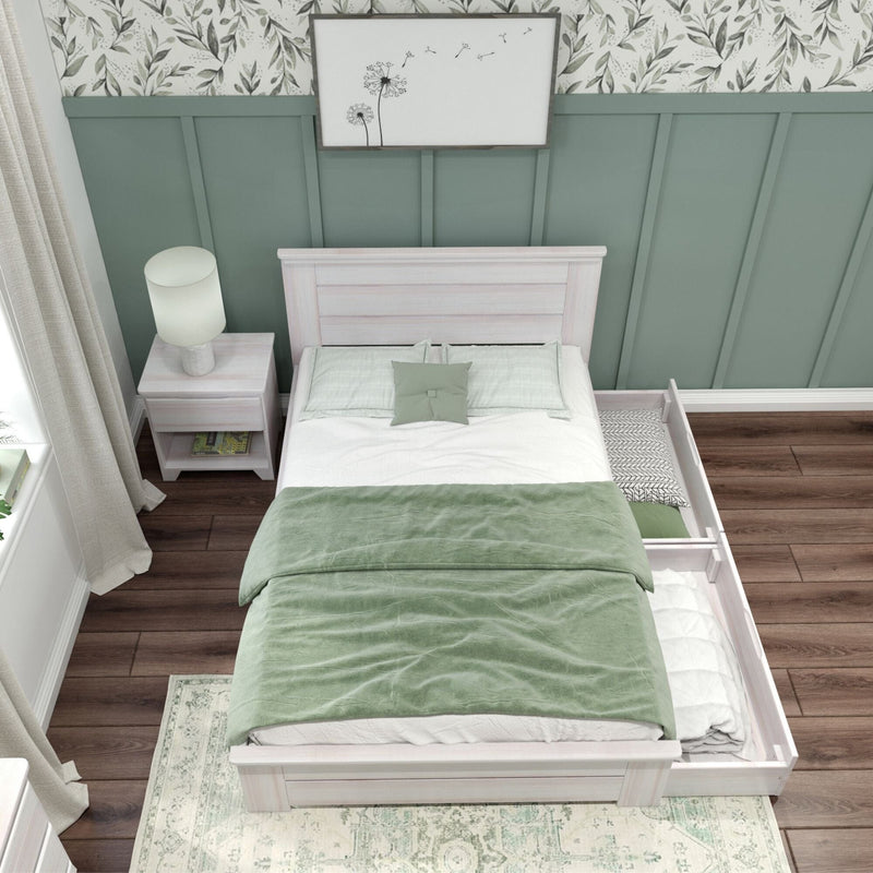 Cozy modern bedroom with green bedding, white wood bed frame, and built-in storage drawers.