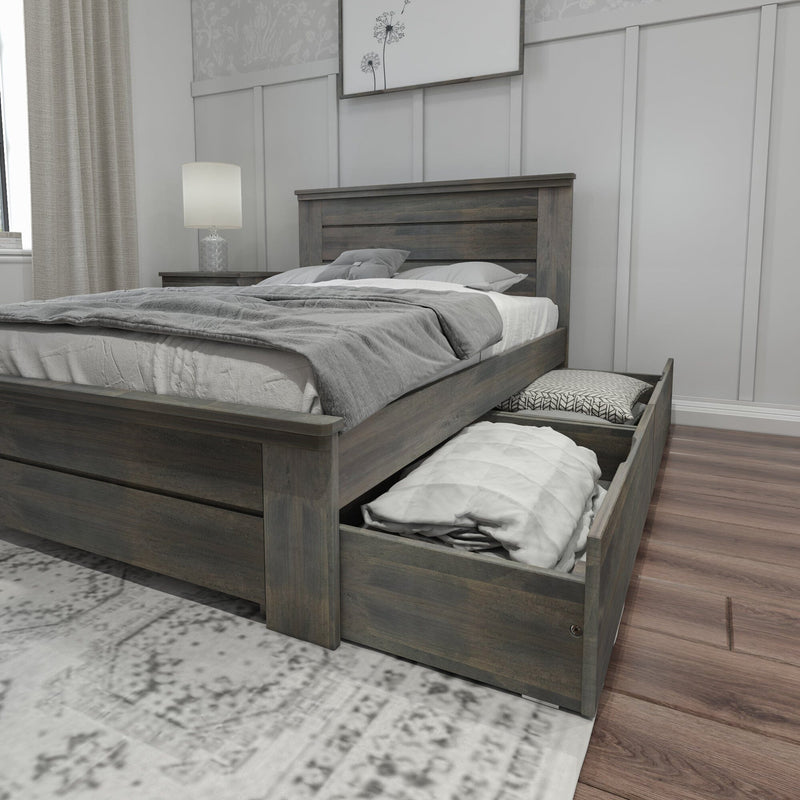Gray wood storage platform bed with pull-out underbed drawers, gray bedding and pillows, nightstand with lamp in modern farmhouse bedroom