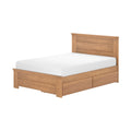 Single solid oak storage bed with paneled headboard and under-bed drawers in natural wood finish with white mattress