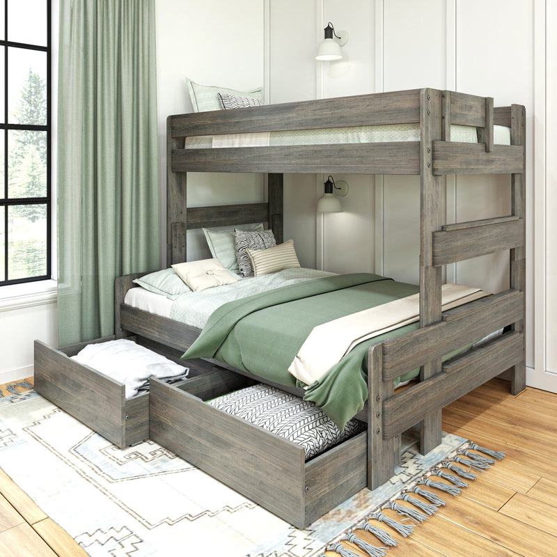 Space-saving rustic gray wood bunk bed with pull-out trundle storage drawers, green linens and patterned pillows in a modern farmhouse kids' bedroom with wall sconces and large window
