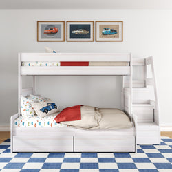 White wooden twin-over-full bunk bed with built-in staircase and under-bed drawers in a children's bedroom, car-themed bedding and vintage car wall art over a blue checkered rug