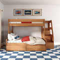 Wooden kids bunk bed with car-print bedding, red blanket, under-bed storage drawers, framed vintage car prints and blue checkered rug