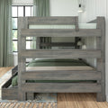 Graywashed twin-over-full wooden bunk bed with pull-out trundle and built-in storage drawer, green bedding, guardrails and wall-mounted reading lamps in a modern farmhouse bedroom with hardwood floors, large window and sage curtains