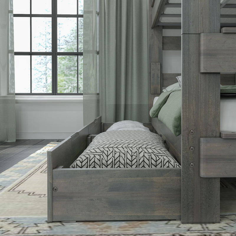Gray wood bunk bed with pull-out trundle mattress, green bedding and patterned pillow by a large window with sheer curtains in a modern bedroom