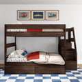 Dark wood kids bunk bed with car-print sheets and pillows, red throw blanket, three framed vintage car prints above, and blue checkered rug in a modern children's bedroom