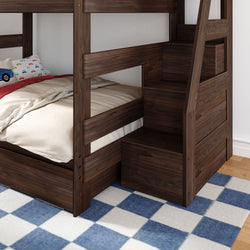 Dark walnut wood twin-over-full bunk bed with built-in storage staircase in kids' room, beige bedding, car-print pillow and blue checkered rug