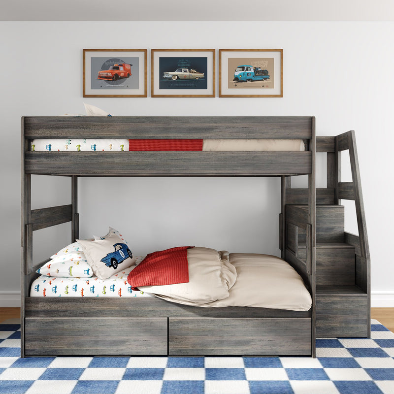 Gray wooden kids bunk bed with car-themed bedding and racing car pillow, red throw blanket, built-in under-bed storage drawers, framed vintage car wall art and blue checkered rug in a modern children's bedroom