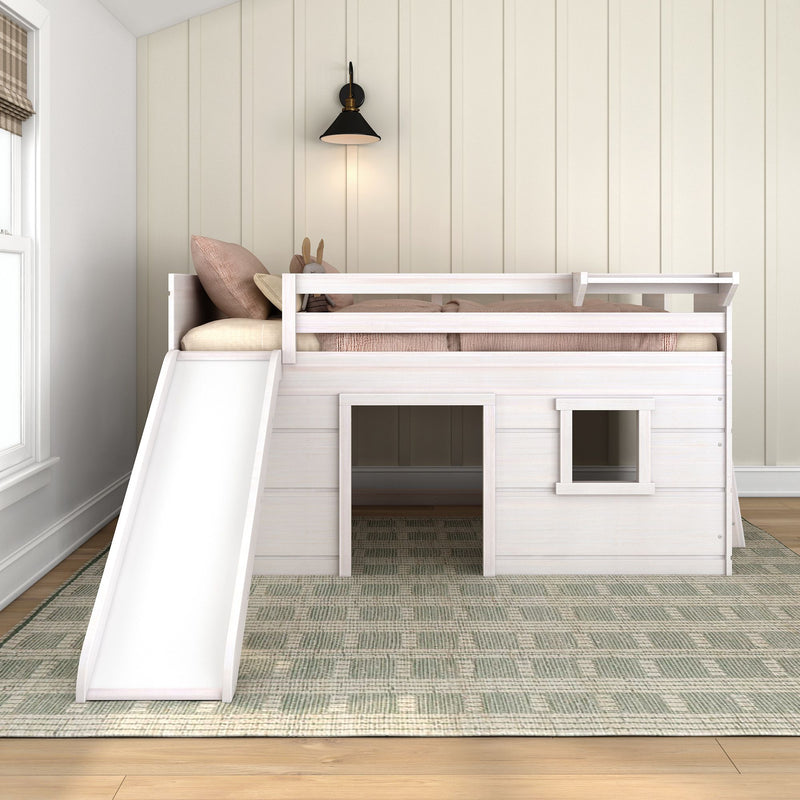 White wooden kids loft bed with slide and playhouse below in a neutral modern children's bedroom, toddler loft bed with guardrails