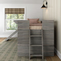 Cozy kids loft bed in gray reclaimed wood with ladder, blush pink bedding, plaid brown Roman shade over white-trim window and black brass wall sconce in a neutral modern farmhouse bedroom