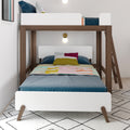 Modern twin-over-twin bunk bed with walnut wood frame, white guardrails and ladder, teal bedding and colorful pillows with pastel striped blanket in a children's bedroom