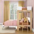 Modern kids bedroom with wooden loft bunk bed, pink comforter and pillows, mustard curtains, pastel pink patterned wallpaper, large window and scalloped rug, ideal children's room décor and bunk bed design