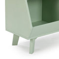 Close-up of mint green mid-century modern wooden cabinet showing angled legs and open shelf