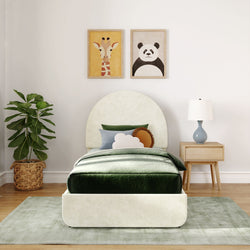Kids bedroom with green velvet bedding, animal art, and modern decor.