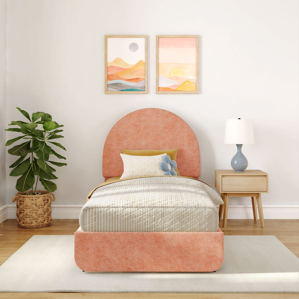 Cozy bedroom with pastel headboard, wooden nightstand, modern lamp, and decorative plant.