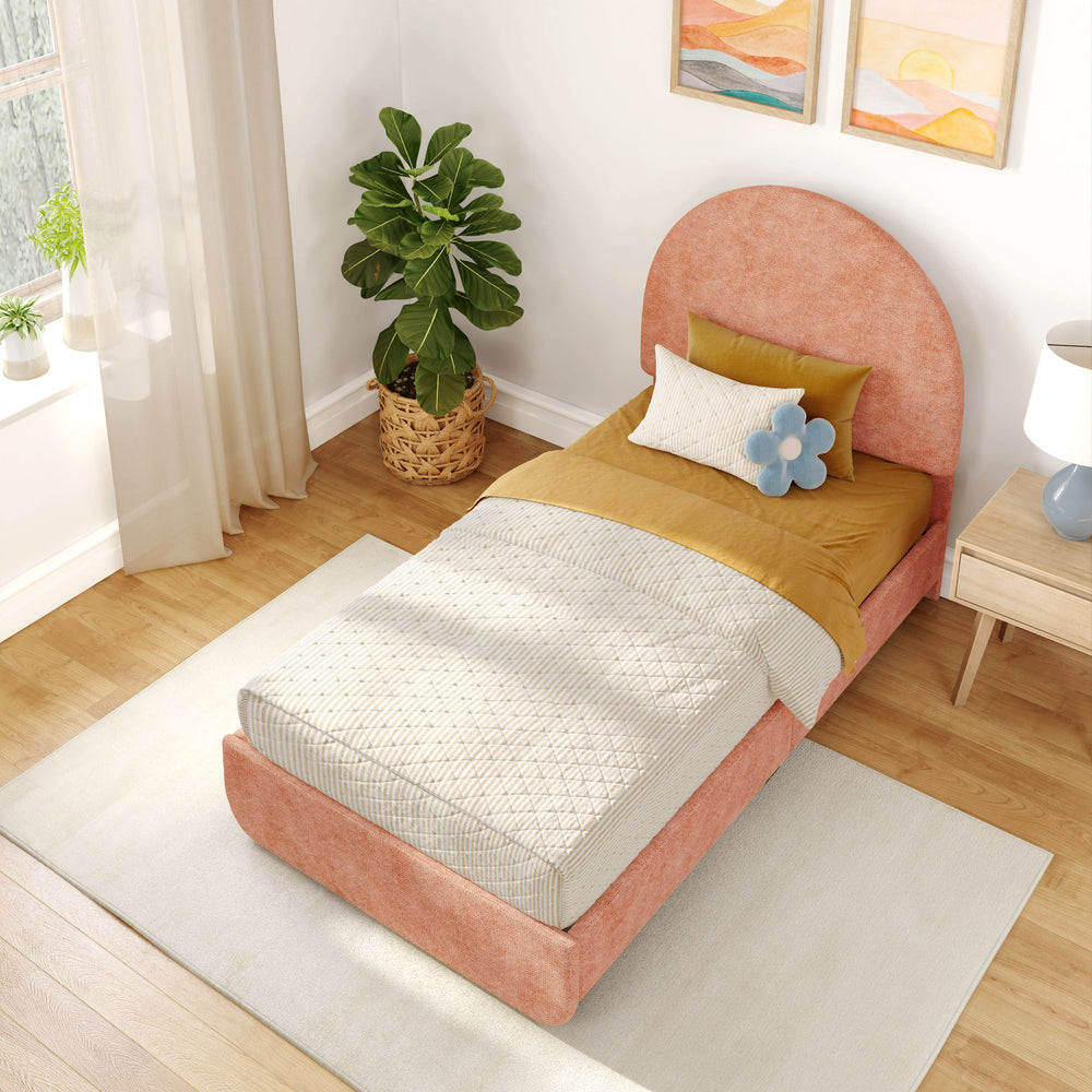Cozy bedroom with orange upholstered bed, modern bedding, indoor plant, and wooden floor.