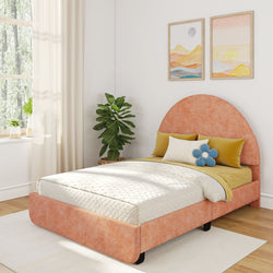 Cozy bedroom with an orange upholstered bed, yellow and blue pillows, and modern wall art, featuring natural light from large windows.