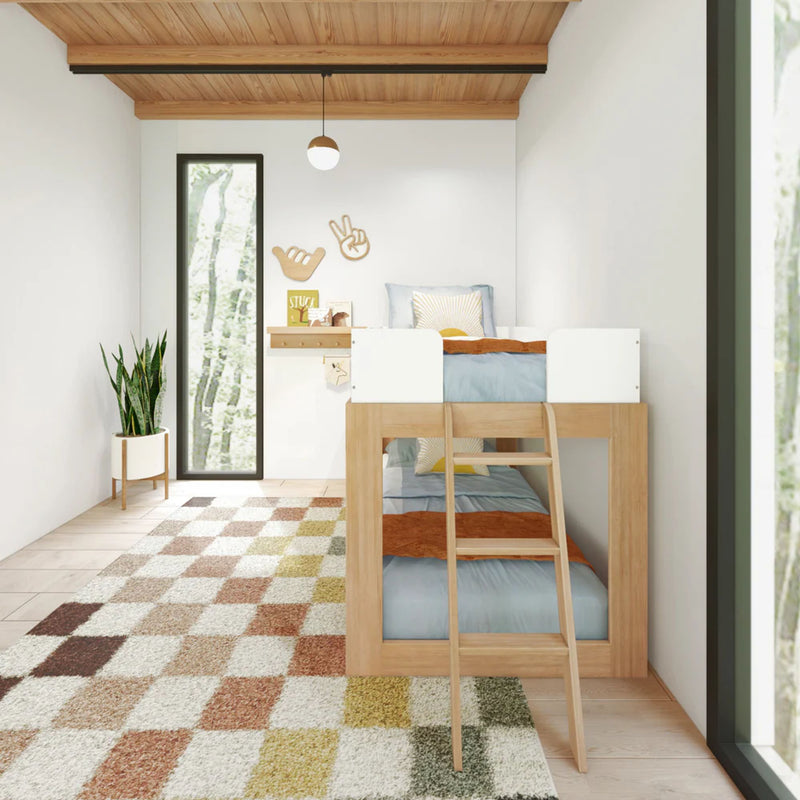 Modern small bedroom with wooden bunk bed, checkered rug, and indoor plant.