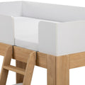 Children's loft bed close-up showing white safety guardrail, fitted mattress and natural wood ladder and frame in minimalist modern design