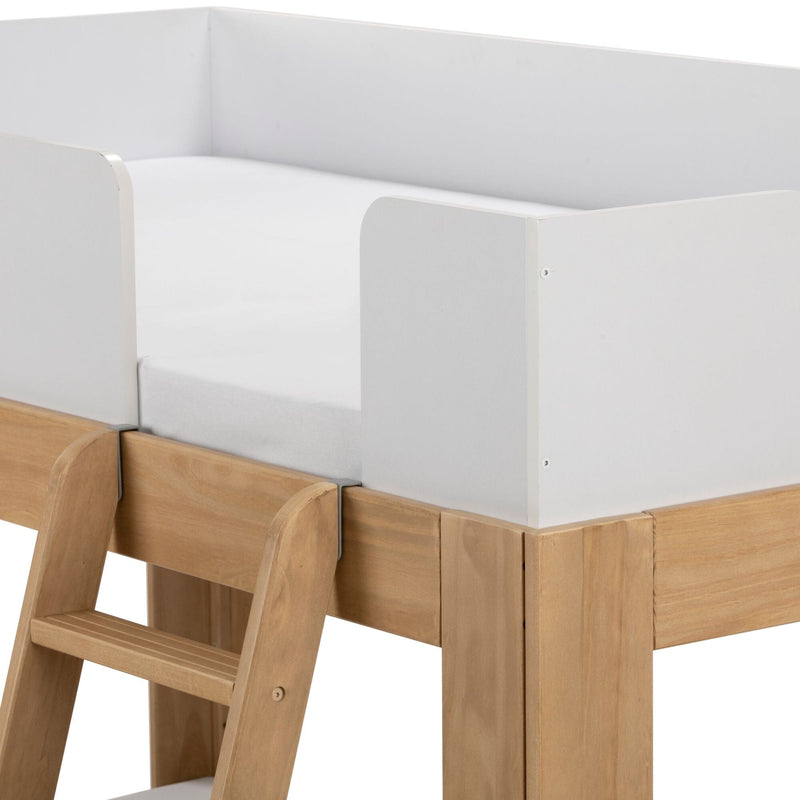 Children's loft bed close-up showing white safety guardrail, fitted mattress and natural wood ladder and frame in minimalist modern design