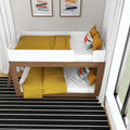 Modern wooden bunk bed with white guard rails and mustard-yellow quilted bedding, colorful accent pillows in a bright kids' bedroom with black-and-white striped rug and large window