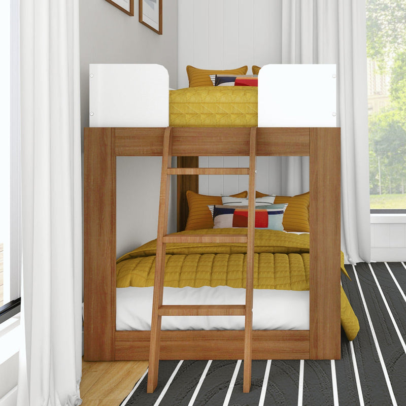 Modern wooden bunk bed with ladder and white safety rails, mustard yellow quilt and colorful pillows in a bright kids' bedroom