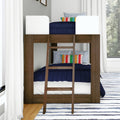 Dark wood bunk bed with ladder, navy quilted bedding, white safety rails and multicolor striped pillows in a bright modern kids' bedroom with white curtains and striped rug