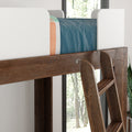 Rustic wooden ladder for kids' bunk bed with white safety guardrail, blue bedding and natural window light