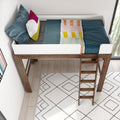 Top view of a modern wooden loft bed with white guardrail and ladder, teal sheets, colorful throw blanket and decorative pillows over a patterned rug